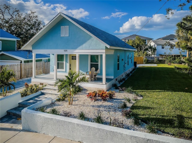 bungalow featuring a front yard and covered porch