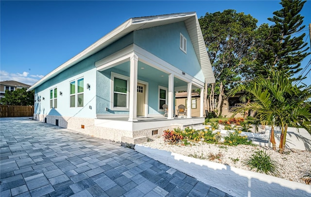 view of side of home with a porch