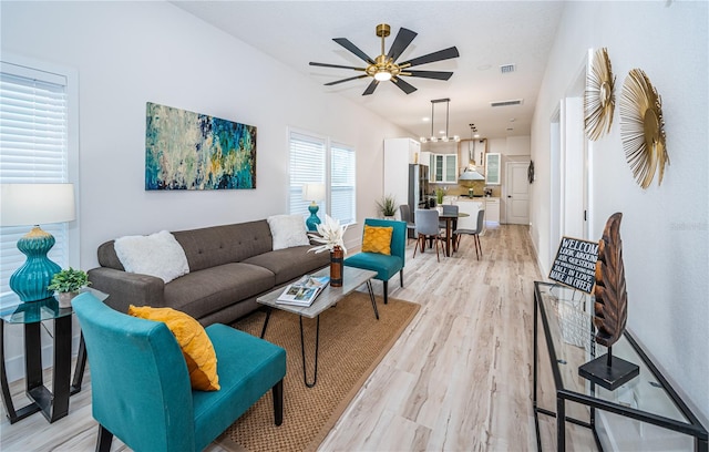 living room featuring light hardwood / wood-style floors and ceiling fan