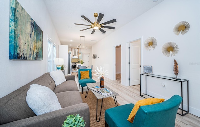 living room with light wood-type flooring and ceiling fan