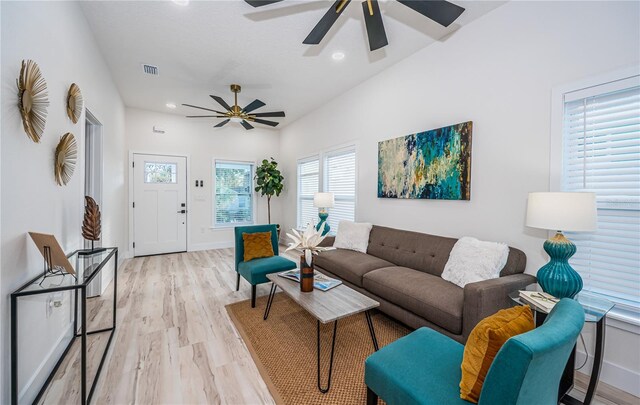 living room with light hardwood / wood-style floors and ceiling fan