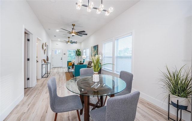 dining space with light wood-type flooring and ceiling fan