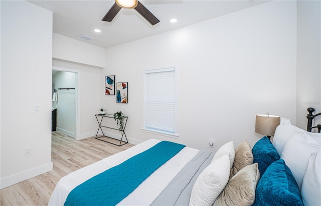 bedroom featuring light hardwood / wood-style flooring, a closet, and ceiling fan