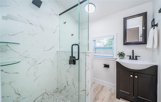 bathroom featuring vanity and a shower with shower door