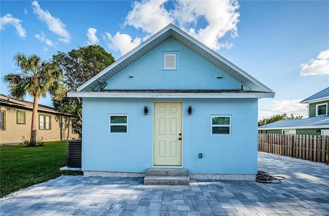 rear view of property with a patio and central AC