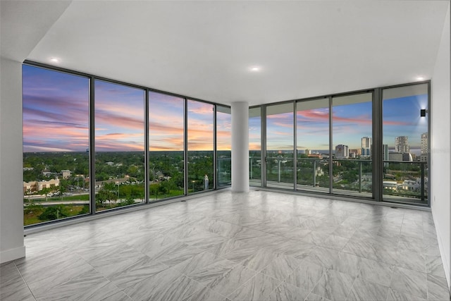 unfurnished room featuring floor to ceiling windows