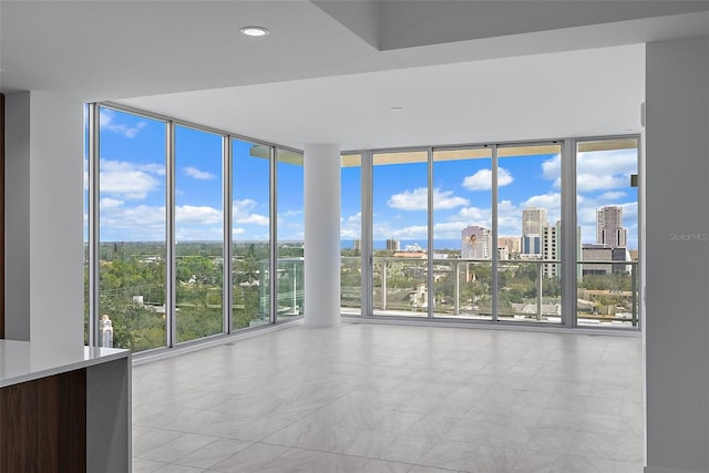 777 3rd Ave N Unit 1203, Saint Petersburg, FL 33701 - spare room featuring a wall of windows, a city view, and light tile patterned floors