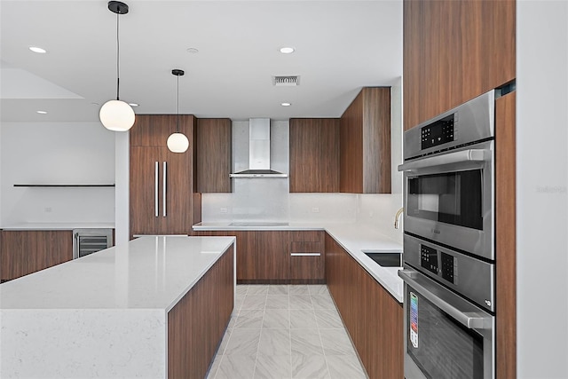 777 3rd Ave N Unit 1203, Saint Petersburg, FL 33701 - kitchen featuring wall chimney range hood, modern cabinets, light countertops, and recessed lighting
