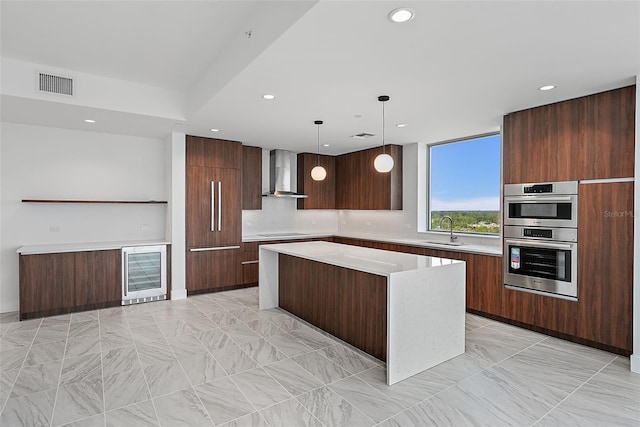 777 3rd Ave N Unit 1203, Saint Petersburg, FL 33701 - kitchen featuring wall chimney range hood, a sink, modern cabinets, beverage cooler, and light countertops