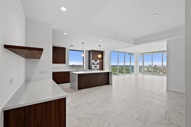777 3rd Ave N Unit 1203, Saint Petersburg, FL 33701 - kitchen with modern cabinets, dark brown cabinets, a kitchen island, open floor plan, and recessed lighting