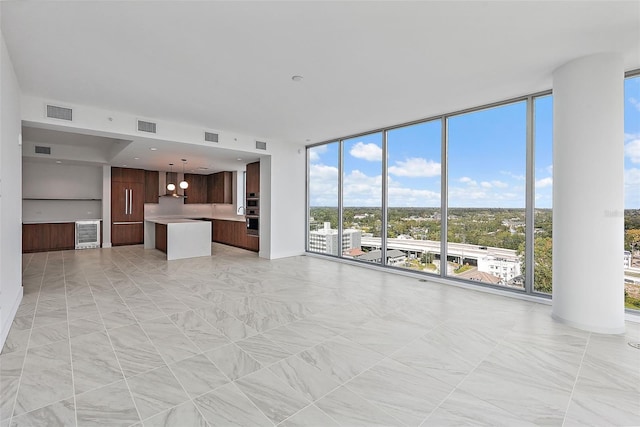 777 3rd Ave N Unit 1203, Saint Petersburg, FL 33701 - unfurnished living room with floor to ceiling windows and healthy amount of natural light