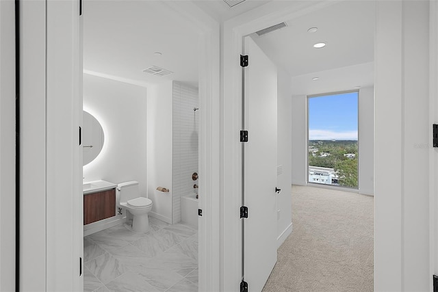 777 3rd Ave N Unit 1203, Saint Petersburg, FL 33701 - bathroom featuring vanity, toilet, bathing tub / shower combination, baseboards, and recessed lighting