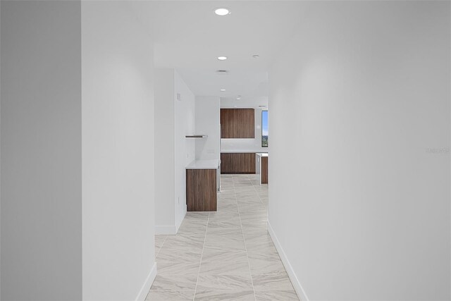 777 3rd Ave N Unit 1203, Saint Petersburg, FL 33701 - hallway featuring light marble finish floors, recessed lighting, and baseboards
