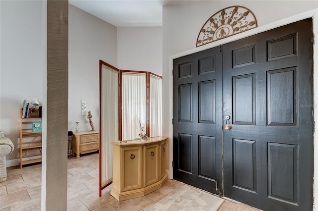 foyer entrance featuring light tile patterned flooring