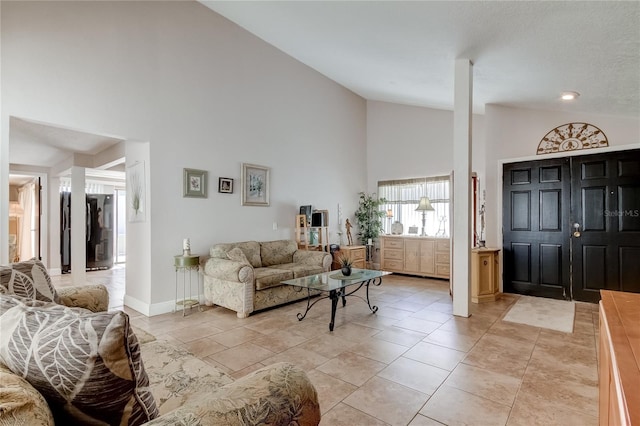 living room with high vaulted ceiling