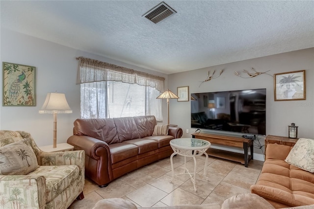 living room with light tile patterned floors and a textured ceiling