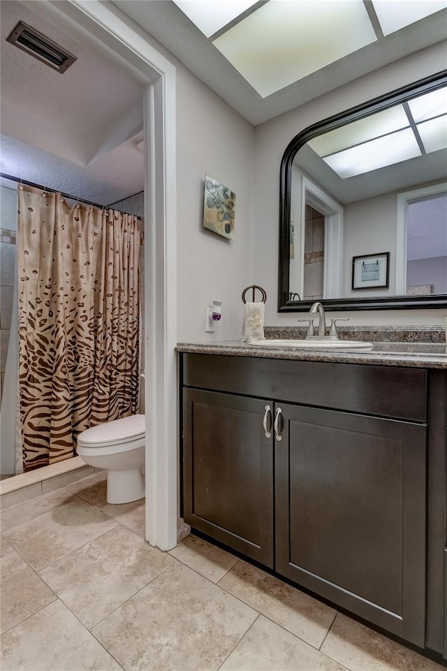 bathroom featuring vanity, a shower with shower curtain, and toilet