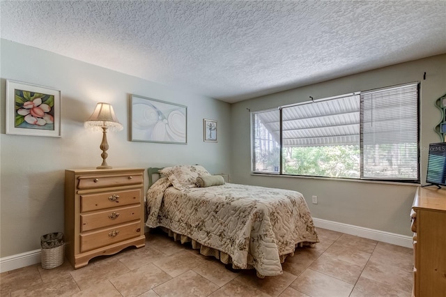 tiled bedroom featuring a textured ceiling