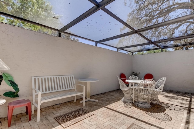 view of patio / terrace featuring a lanai