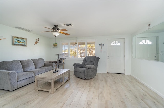 living room featuring light wood-type flooring and ceiling fan