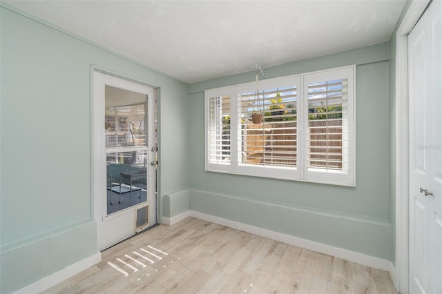 spare room with light hardwood / wood-style flooring