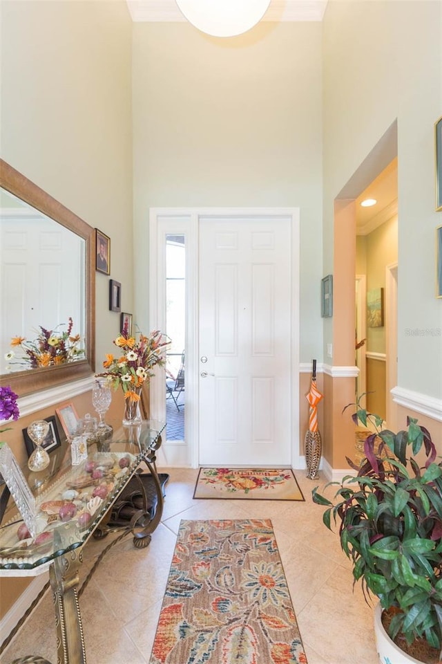 foyer entrance featuring a high ceiling and light tile patterned flooring