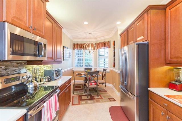 kitchen featuring hanging light fixtures, stainless steel appliances, backsplash, crown molding, and an inviting chandelier