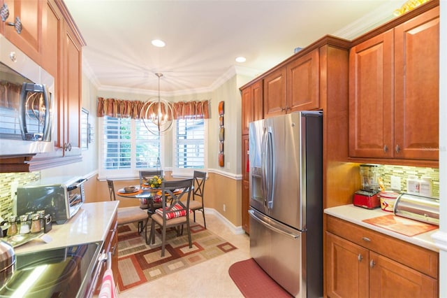 kitchen with tasteful backsplash, stainless steel appliances, decorative light fixtures, crown molding, and a chandelier