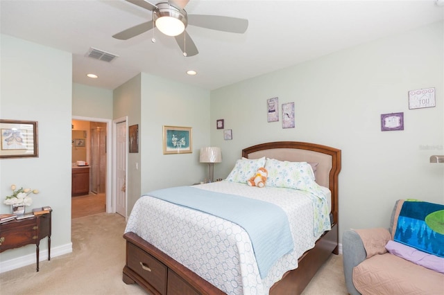 bedroom featuring light carpet, connected bathroom, and ceiling fan