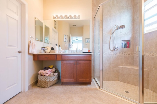 bathroom with vanity and a shower with shower door