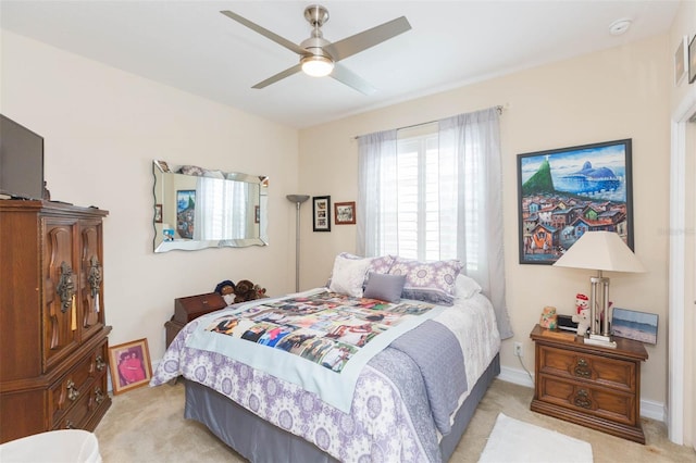 bedroom featuring light colored carpet and ceiling fan