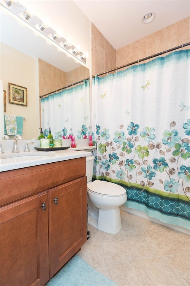 bathroom featuring vanity, toilet, and tile patterned floors