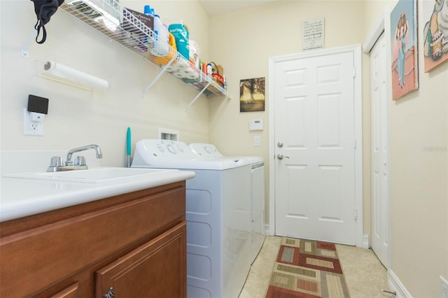 clothes washing area featuring washing machine and dryer and cabinets