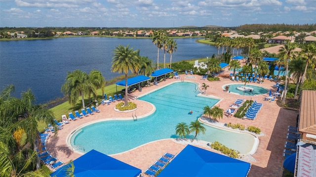 view of pool featuring a patio area and a water view