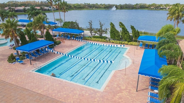 view of pool with a patio and a water view