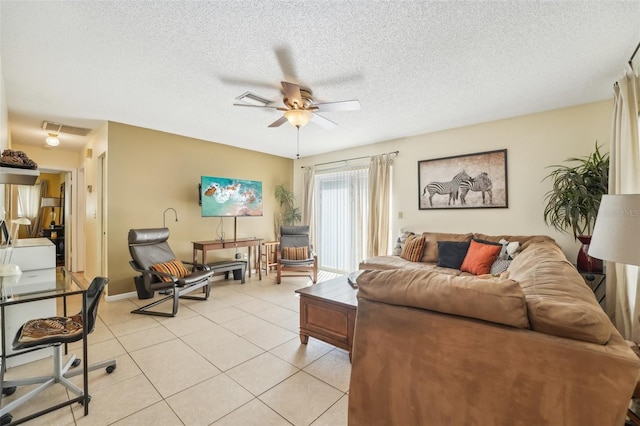 tiled living room with a textured ceiling and ceiling fan