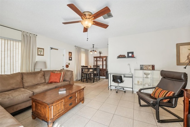 living room with ceiling fan and light tile patterned floors