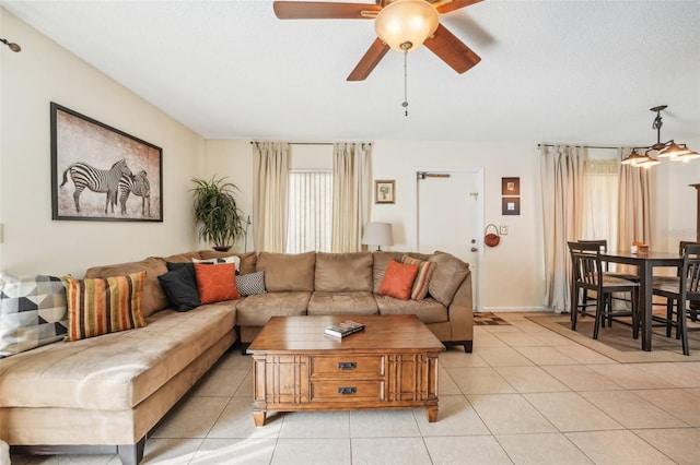 tiled living room with a textured ceiling and ceiling fan