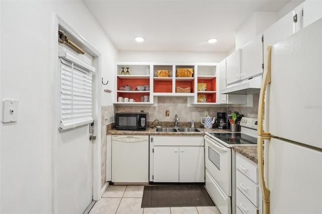 kitchen featuring sink, tasteful backsplash, light tile patterned flooring, white cabinetry, and white appliances