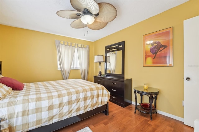 bedroom featuring wood-type flooring and ceiling fan