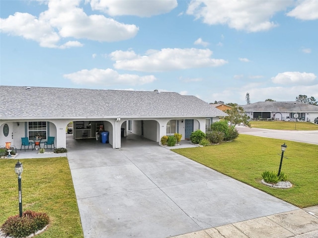 ranch-style house with a carport and a front lawn