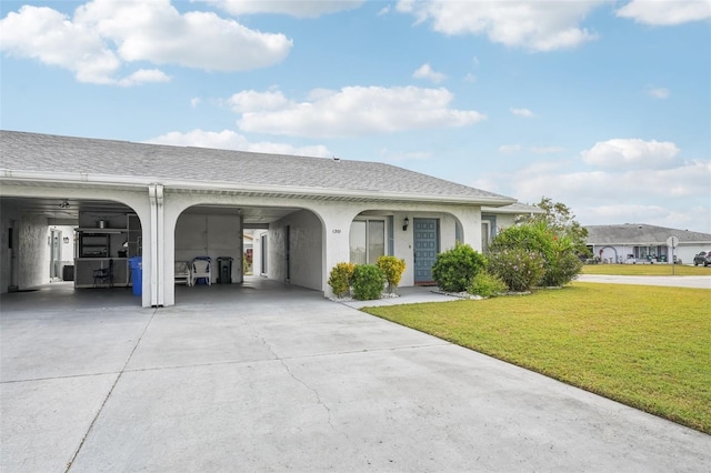 ranch-style house with a carport and a front lawn