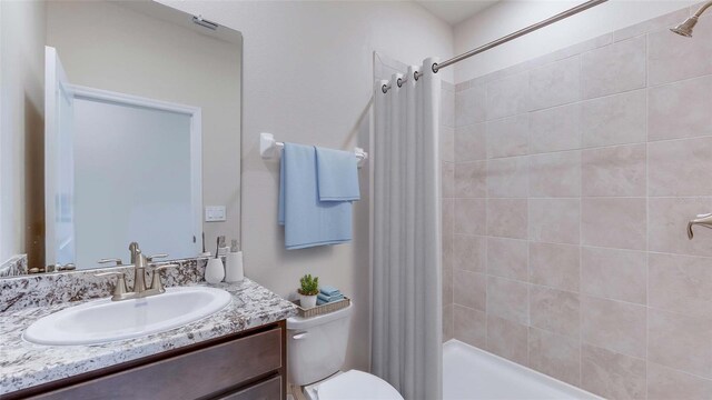 bathroom with toilet and vanity