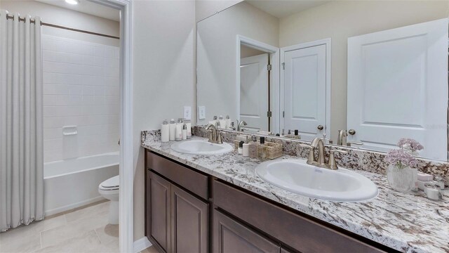 full bathroom with vanity, tile patterned floors, toilet, and tub / shower combination