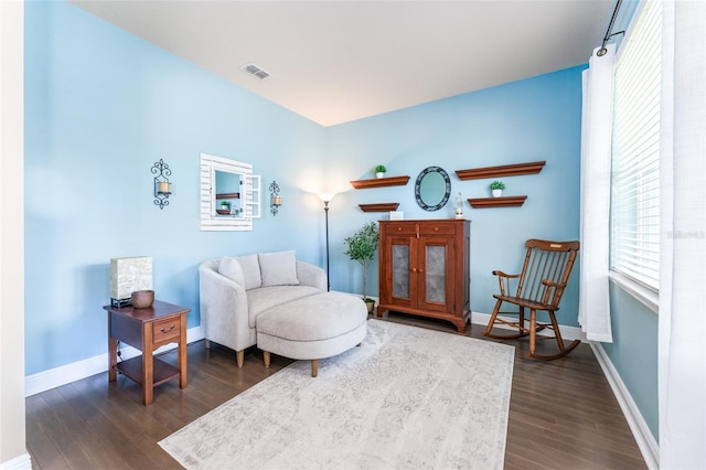 sitting room with dark wood-type flooring