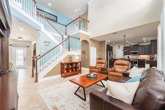 tiled living room with a high ceiling