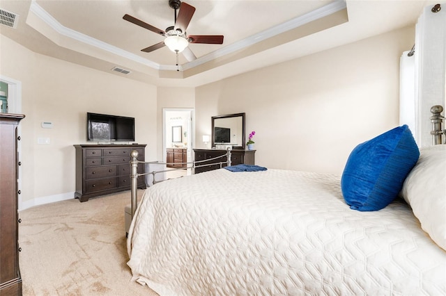 carpeted bedroom with ornamental molding, ceiling fan, and a raised ceiling