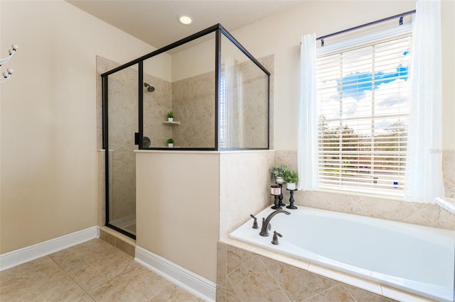 bathroom featuring tile patterned flooring and separate shower and tub