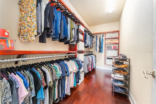 spacious closet with dark hardwood / wood-style flooring