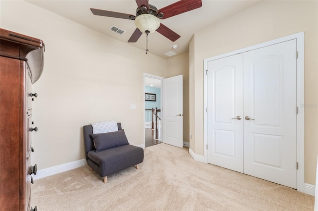 sitting room with light carpet and ceiling fan